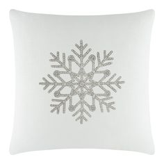 a white pillow with silver snowflakes on it