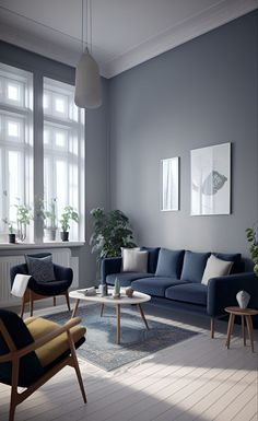 a living room with blue couches and chairs in front of two large windows on the wall