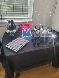 a table topped with an ice tray and a neon sign