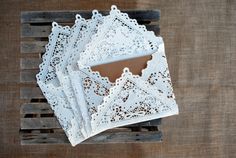 four white doily sitting on top of a wooden table