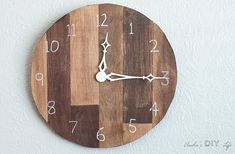 a wooden clock with white numbers on it