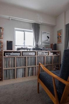 a living room filled with furniture and lots of records