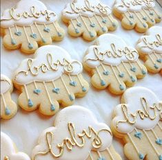 some cookies that are sitting on a table with blue icing and gold foil lettering