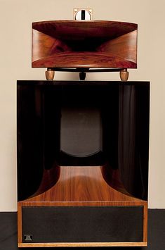 an old fashioned television sitting on top of a wooden stand with two speakers in front of it