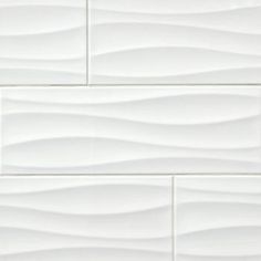 a white tile wall with wavy lines on it