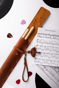 a pair of scissors and some music sheets on a table