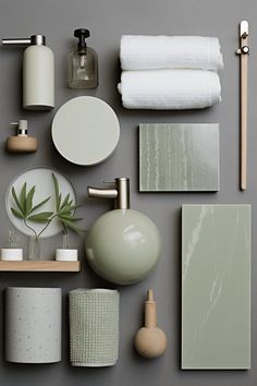 various bathroom accessories arranged on a gray surface with white and green accents, such as toilet paper, soap dispenser, toothbrush