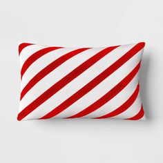 a red and white striped pillow sitting on top of a table