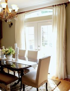 a dinning room table with chairs and a chandelier