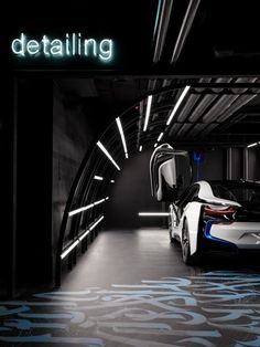 the bmw i8 concept car is shown in an underground parking garage with its door open