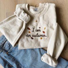 Get cozy with our "I am an autumn" embroidered crewneck! This adorable embroidered fall sweatshirt is perfect for autumn and cozy vibes. Whether you're curating a boo basket gift, wanting a cute embroidered sweatshirt for fall, or looking for the ideal Christmas gift, this fall crewneck is a must-have. It's soft, stylish, and the perfect matching sweatshirt for those chilly October nights.  Embrace the season with our "I am an autumn" embroidered crewneck, the ultimate fall shirt for couples! Ideal for matching shirts with your partner or as a fun fall shirt to wear while watching your favorite fall tv show, going to a football game or other fall events, it's a timeless piece to keep you warm and festive all season long. Cute Fall Clothes, Fall Tv Shows, Cute Sweaters For Fall, Fall Tv, Fall Events, Matching Sweatshirts, Embroidered Crewneck, Cute Fall Outfits, Cute Sweaters