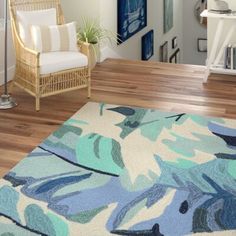 a blue and green rug in a living room