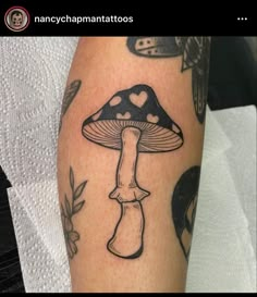 a black and white photo of a mushroom with hearts on it's leg,