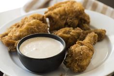 fried chicken and dipping sauce on a white plate