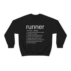 "Crafted with high-quality Gildan sweatshirt material, this minimalist Running Crewneck is designed for comfort and durability during your runs. With its classic design, it can easily be paired with any running shorts or leggings. This sweatshirt for runners is perfect for both seasoned runners and those just starting out. Its simple yet stylish design features the definition of the word \"runner\" boldly printed on the front, making a statement wherever you go. This running sweatshirt is not ju Crew Neck Sweatshirt With Funny Text For Streetwear, Casual Long Sleeve T-shirt For Running, Black Sports Sweatshirt With Text Print, Black Crew Neck Sweatshirt With Funny Text, Running Sweatshirts, Running Partner, Marathon Gift, Gildan Sweatshirt, Gifts For Runners