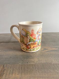 a coffee cup sitting on top of a wooden table