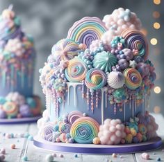 there is a colorful cake decorated with icing and candies on the table next to it