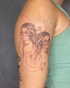 a woman's arm with a tattoo on it that has two women in the background