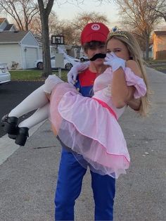 two people dressed up as mario and princess peach