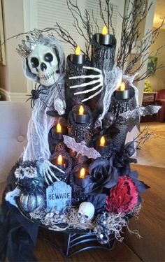 a decorated halloween tree with candles and skulls