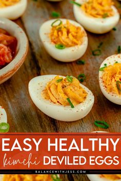 deviled eggs on a wooden table with text overlay that reads easy healthy deviled eggs