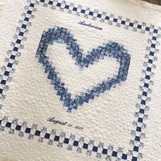 a blue and white quilt with a heart on it