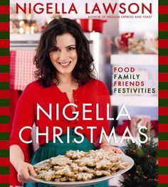 a woman holding a plate of food in front of a book cover that reads,'nigglela christmas '