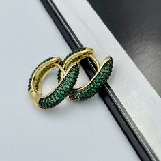 These beautiful and trendy emerald green huggie hoop earrings will make an excellent gift for yourself or friends. 18K real gold plated over brass, emerald green colored Cubic Zirconia. Measurements: Outer diameter - 17 mm Inner diameter - 10 mm These earrings would be a PERFECT GIFT for you and your family and friends! Our jewelry comes beautifully packaged in a gift box!   Click here to see more Modern Everyday Earrings: https://etsy.me/2UJldl1 Thank you for your visit! Emerald Green CZ Huggie Cheap Statement Green Hoop Earrings, Elegant Green Huggie Jewelry, May Birthstone Round Hoop Earrings For Pierced Ears, May Birthstone Round Hoop Earrings, Elegant Green Hoop Huggie Earrings, Elegant Green Huggie Hoop Earrings, Trendy Small Hoop Green Earrings, Green Huggie Earrings For May Birthstone, Trendy Small Hoop Earrings In Green