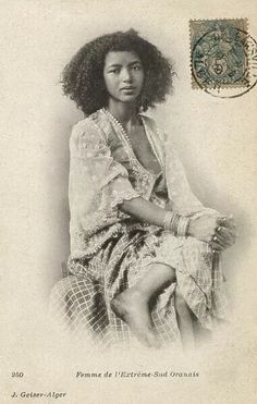 an old photo of a woman with curly hair