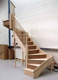 a set of stairs in a room with boxes on the floor