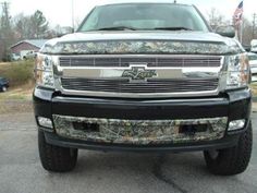 the front end of a truck that is camouflaged