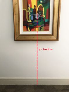 a painting hanging on the wall next to a red line showing where it is located