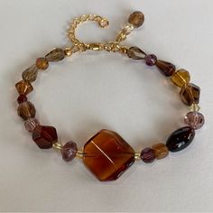 Amber Crystal And Czech Glass Beaded Bracelet From Desert Beads In 7.25" Approx. Length You Will Not Believe The Beautiful Colors In This Statement Bracelet: Amber, Gold, Dark Purple, Lavender, Honey, Champaine, Citrine, And Ruby. It Is Made With Stunning Crystals And Czech Glass Beads; It Even Has A Charm Made From The Same Beads. It Also Has One Small Piece Of Real Amber In It, Can You Guess Which One? All Strung On High Quality Jewelry Wire, It Has An Adjustable Chain, And Lobster Claw Closur Shifting Closet, Czech Glass Bead Bracelet, Nugget Bracelet, Glass Beaded Bracelet, Lavender Honey, Boho Wrap Bracelet, Brown Bracelet, Amber Crystal, Amber Bracelet