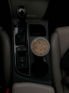 the interior of a car with an automatic cup holder and drink dispenser