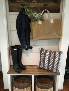 the entryway is decorated with baskets and boots