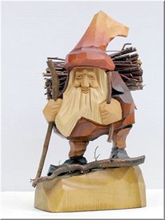 a statue of a man with a hat and cane on top of a wooden block