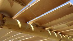 the underside of a wooden structure with nails on it