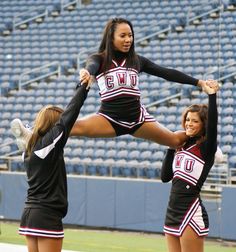 two cheerleaders are doing tricks on the field