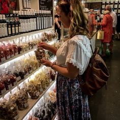 a woman looking at items in a store