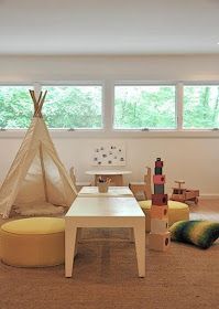 a child's playroom with toys and teepee tent