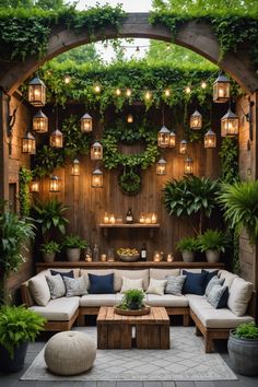 an outdoor living area with couches, tables and potted plants on the wall