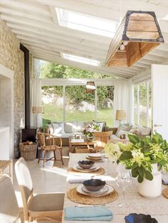 a living room filled with furniture and a fire place in the middle of it's center