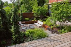 a wooden deck surrounded by plants and trees