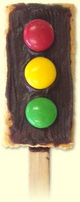 a close up of a candy bar with a traffic light on it's stick