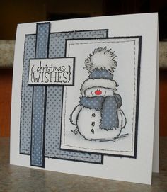 a christmas card with a snowman wearing a knitted hat and scarf on it