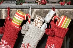 three christmas stockings hanging from a fireplace