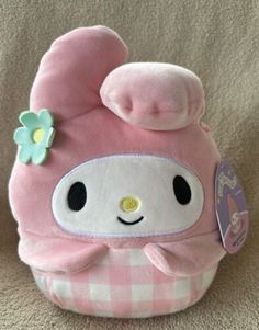 a pink stuffed animal with a flower on it's head