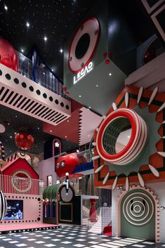 the interior of a children's play area with toys and decorations on display in an open space