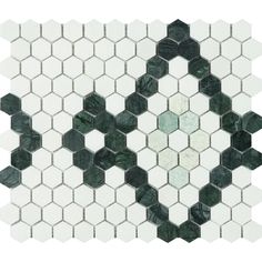 a white and green mosaic tile with hexagonal shapes