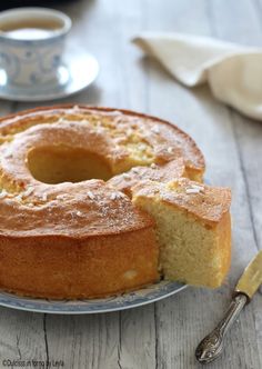 a bundt cake on a plate with one slice cut out and ready to be eaten